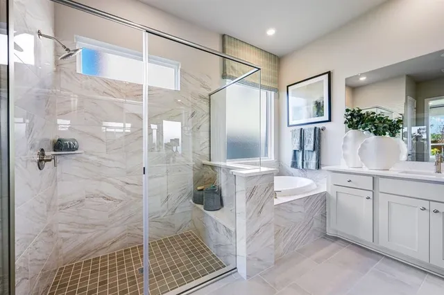a bathroom with a shower sink and mirror