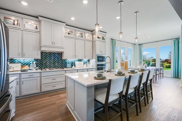 a spacious bedroom with a bed and a chandelier