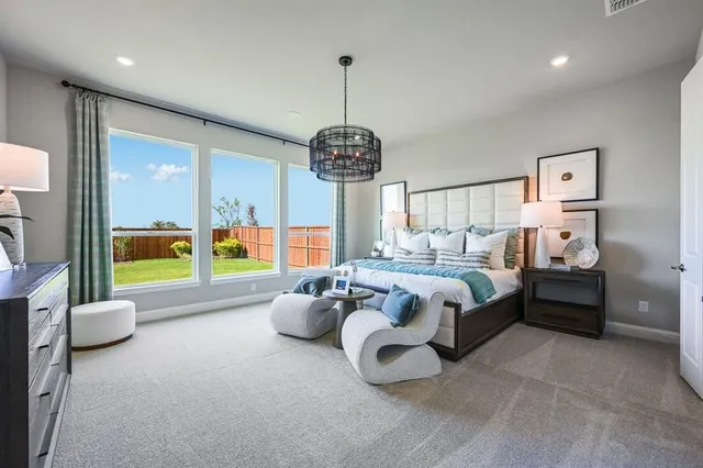 a bedroom with a bed and a chandelier