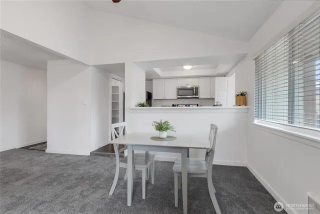 a dining room with furniture and window