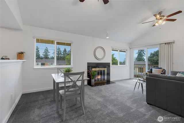 a living room with furniture a fireplace and a window