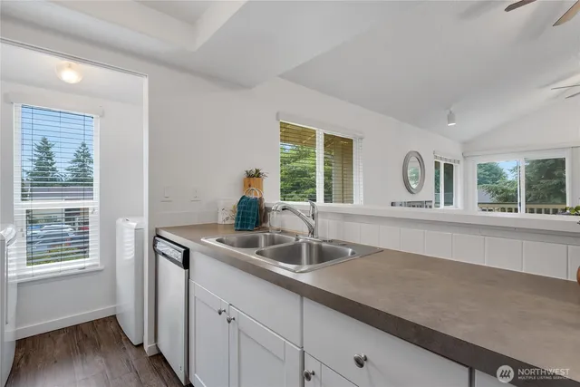 a kitchen with a sink and large window
