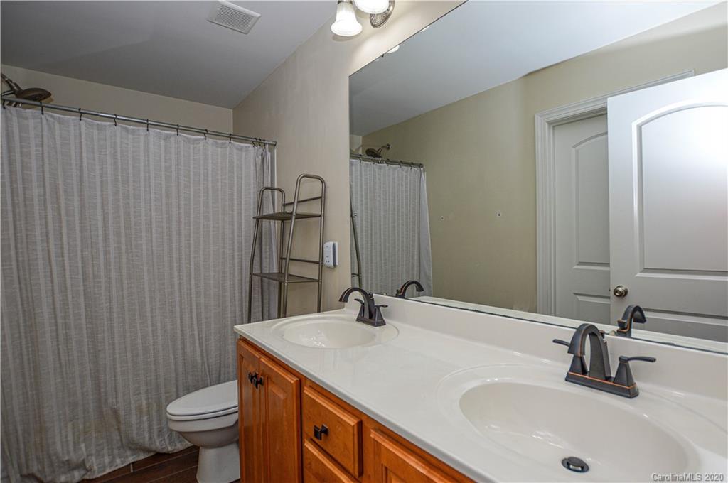 5699 Stafford Road Charlotte, NC 28215 - Photo 21 of 23 a bathroom with a sink toilet and shower