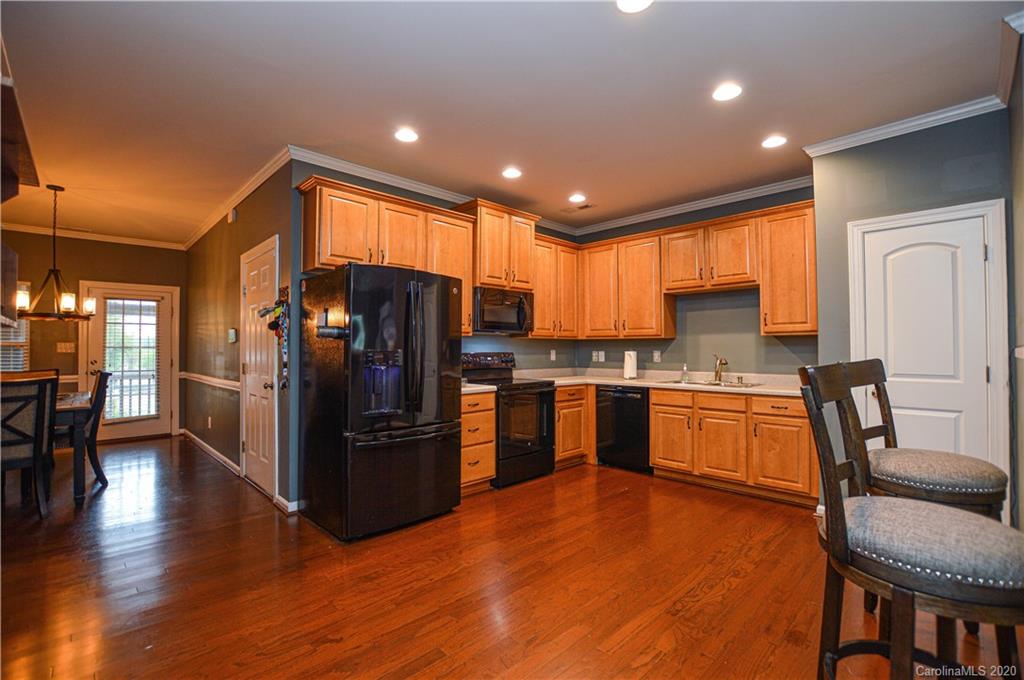 5699 Stafford Road Charlotte, NC 28215 - Photo 7 of 23 a kitchen with granite countertop stainless steel appliances a refrigerator a stove top oven and sink