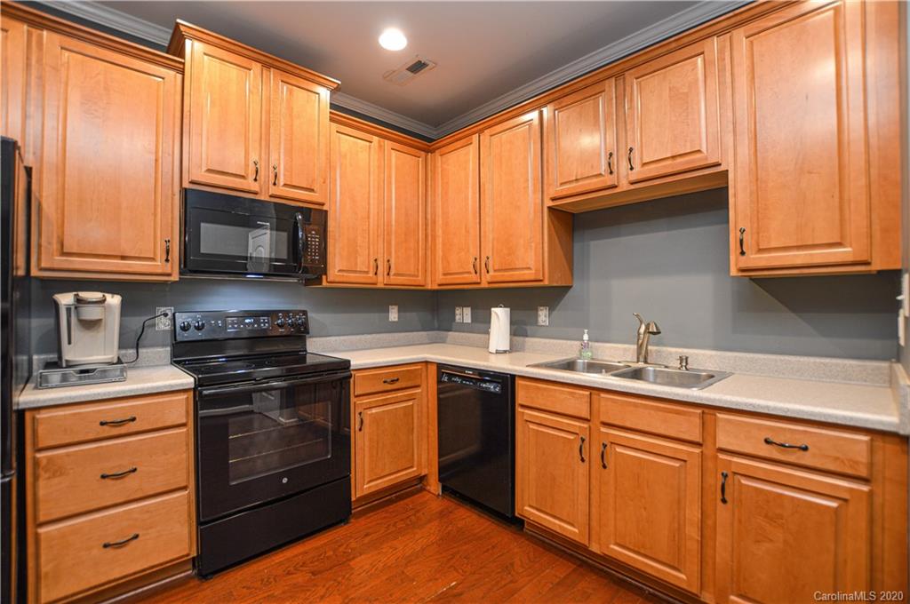 5699 Stafford Road Charlotte, NC 28215 - Photo 8 of 23 a kitchen with granite countertop stainless steel appliances a stove sink and cabinets
