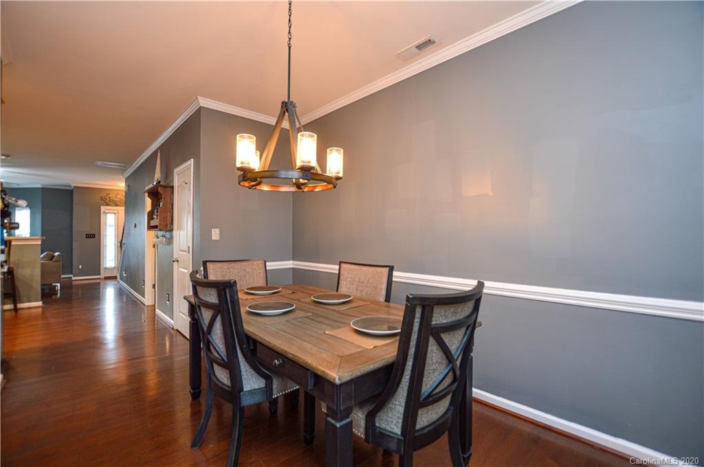 5699 Stafford Road Charlotte, NC 28215 - Photo 10 of 23 a view of a dining room with furniture and wooden floor