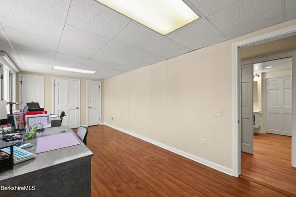 a room with wooden floor and cabinets