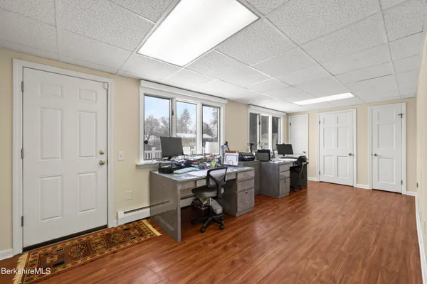 a view of a workspace with furniture and a window