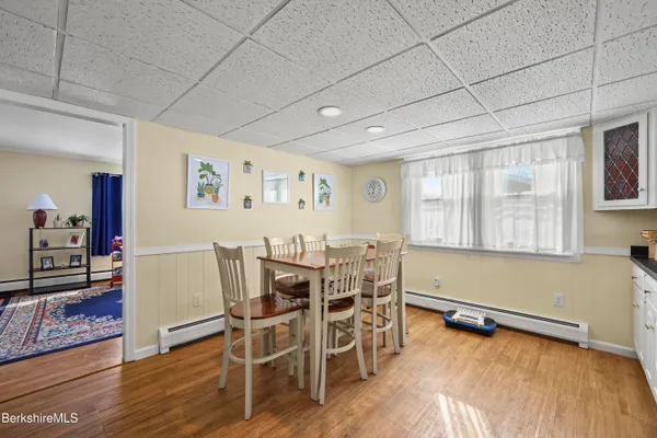 a view of a dining room with furniture and wooden floor