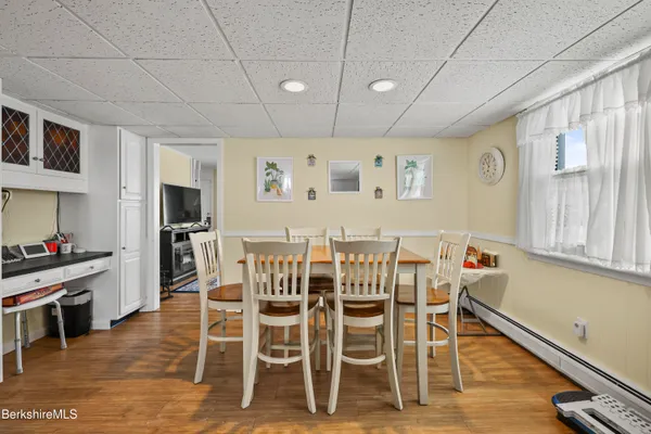 a view of a dining room with furniture and wooden floor