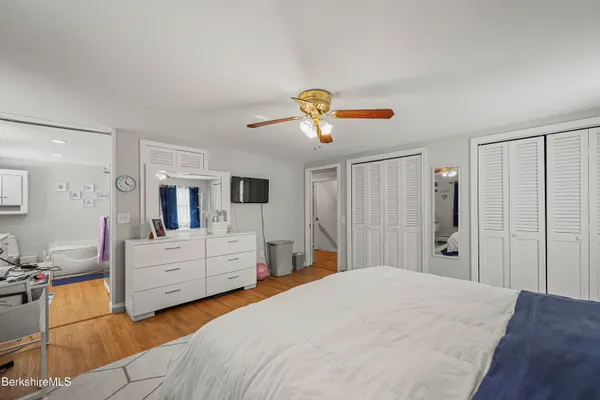 a bedroom with a large bed and dresser
