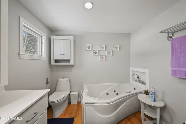 a white bath tub sitting next to a white toilet and sink