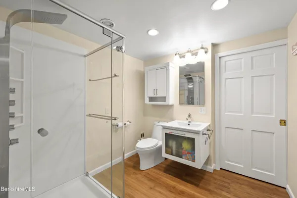 a bathroom with a sink toilet and shower
