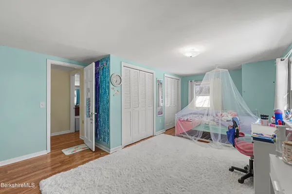 a bedroom with furniture and a window