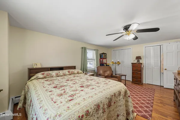 a bedroom with a large bed and a chandelier