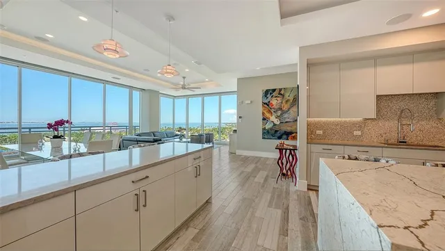 a living room with furniture and a floor to ceiling window