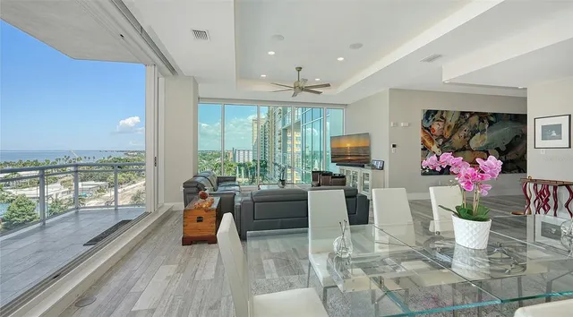 a large kitchen with stainless steel appliances kitchen island granite countertop a table and chairs in it