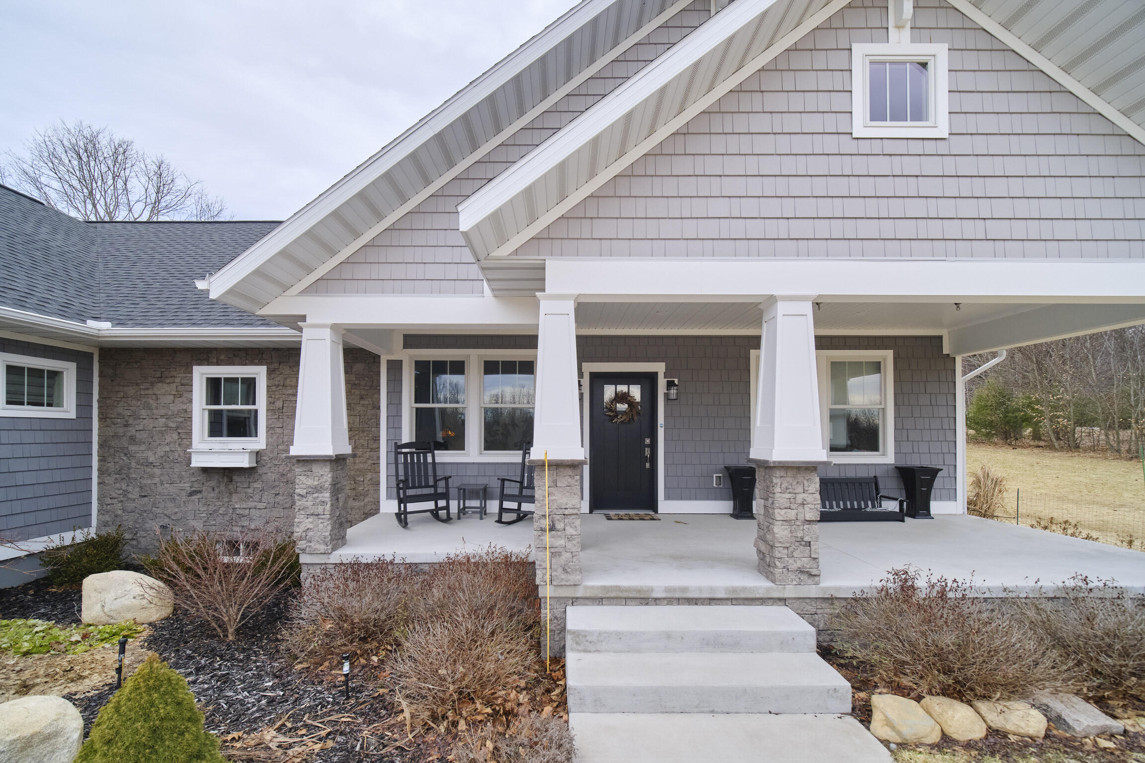 10201 Opal Ridge Drive Onekama, MI 49675 - Photo 60 of 88 Stone columns on front porch