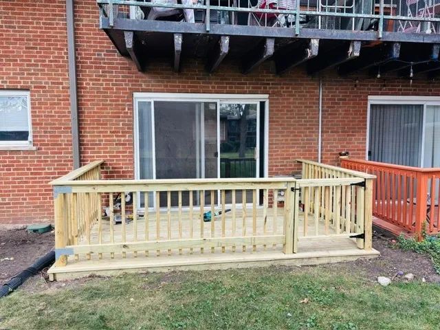 a view of a house with a wooden deck