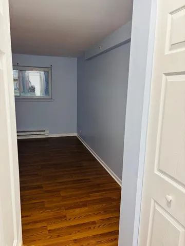 a view of a room with wooden floor and staircase