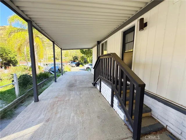 a view of porch with furniture and garden