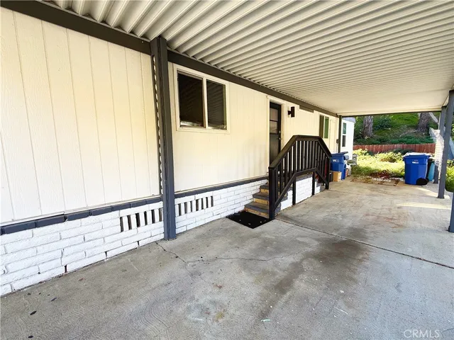 a view of a porch with furniture and a garage