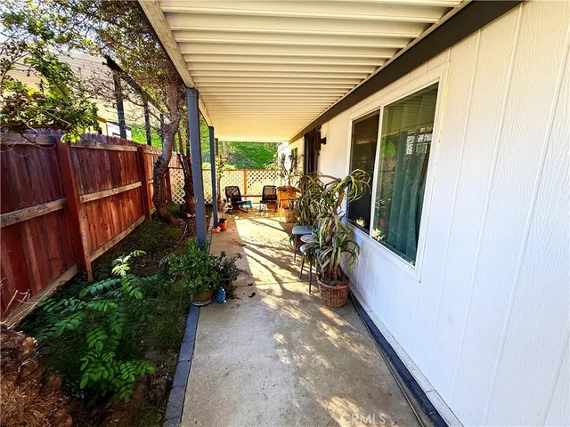 a view of a patio with chairs and potted plants
