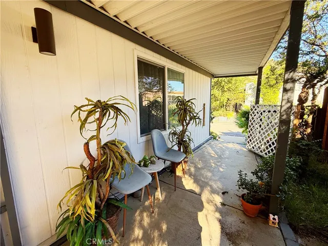 a view of a porch with furniture and backyard