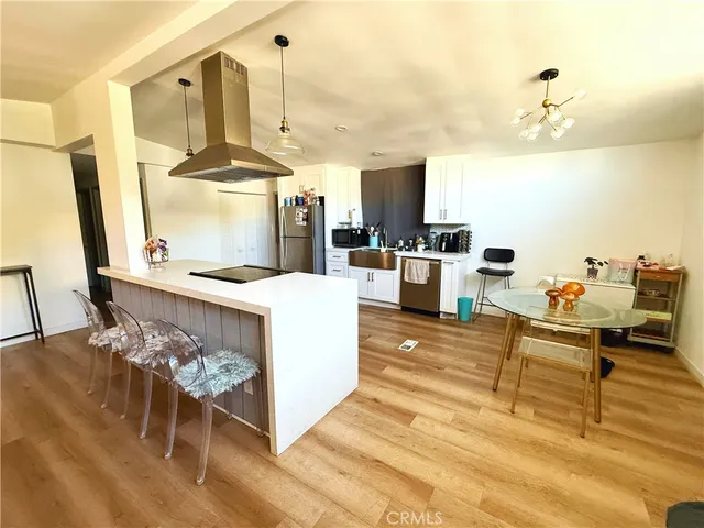 a living room with couches chairs and a coffee table with wooden floor