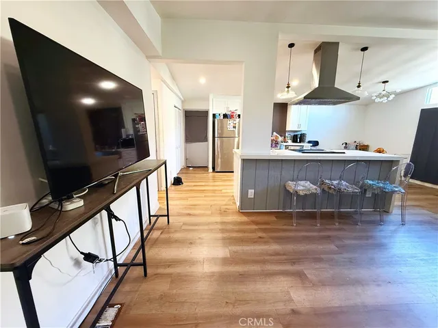 a kitchen with stainless steel appliances granite countertop a sink a stove and a wooden floors