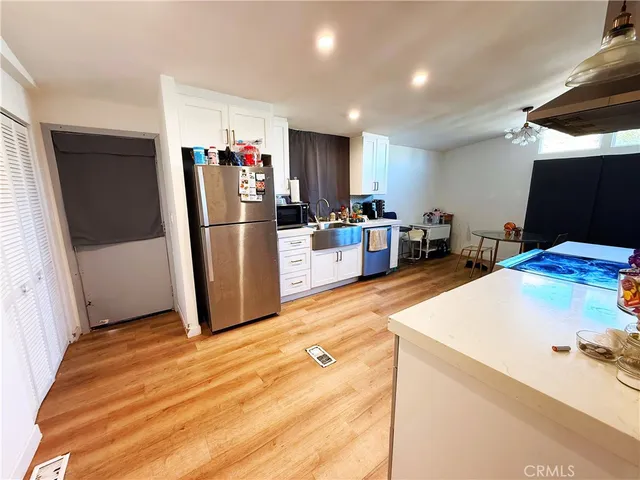 a kitchen with a refrigerator and a sink
