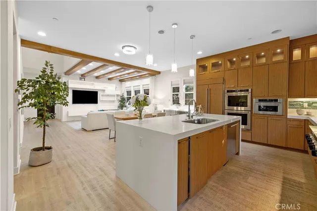 a kitchen with a sink stainless steel appliances and white cabinets