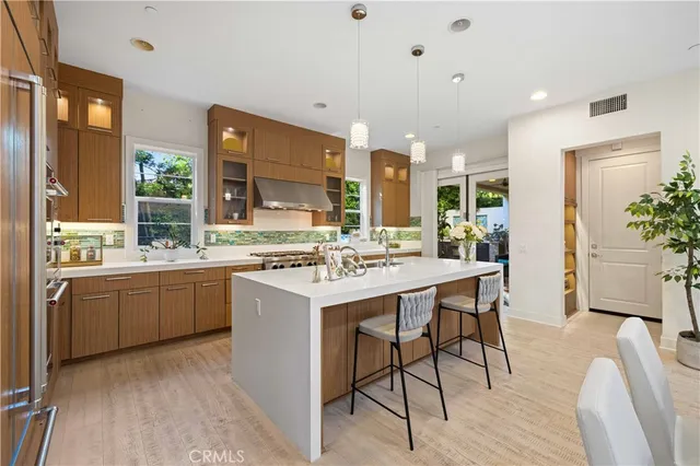 a kitchen with kitchen island granite countertop a sink and white cabinets