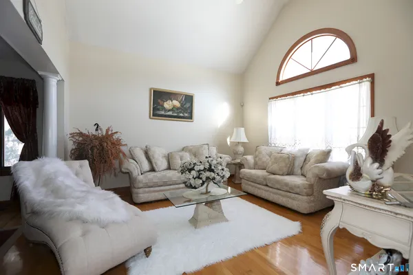a living room with furniture fireplace and window