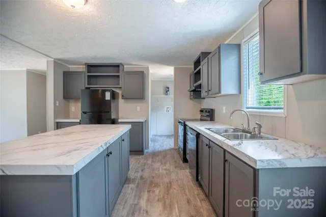 a kitchen with a sink stove and refrigerator