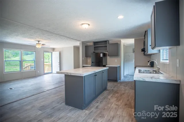 a kitchen with granite countertop a sink and a stove top oven