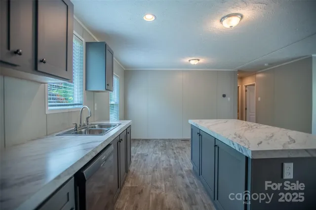 a kitchen with sink cabinets and wooden floor