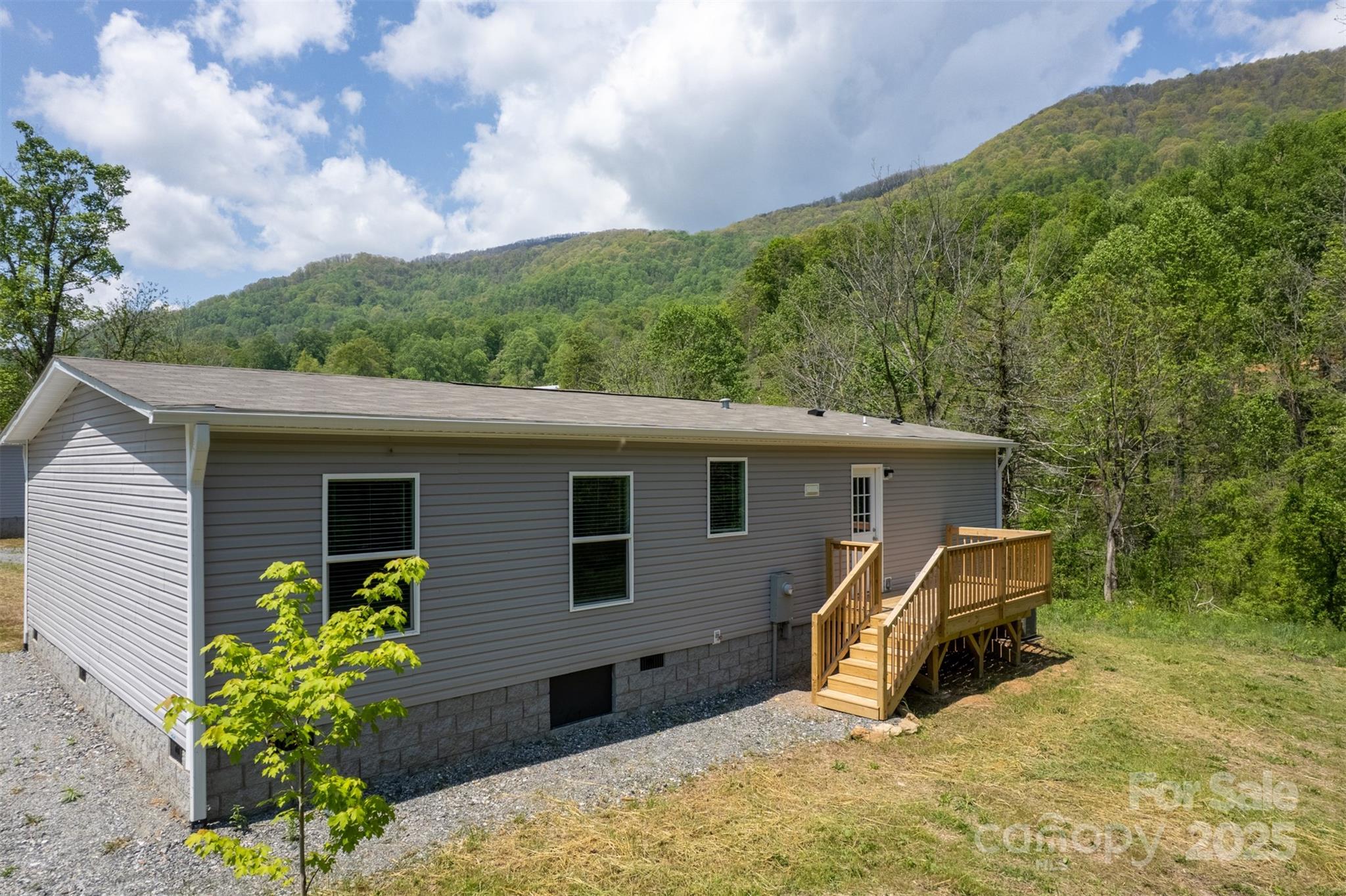 1451 Newfound Road Leicester, NC 28748 - Photo 2 of 39 a view of a backyard with couches under an umbrella