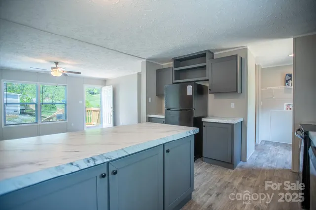 a kitchen with cabinets and window