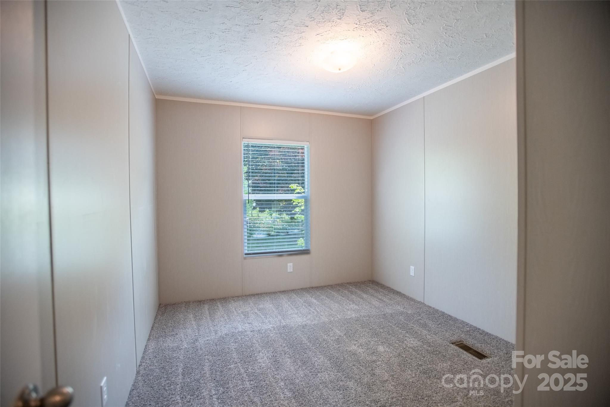 1451 Newfound Road Leicester, NC 28748 - Photo 23 of 39 an empty room with a window
