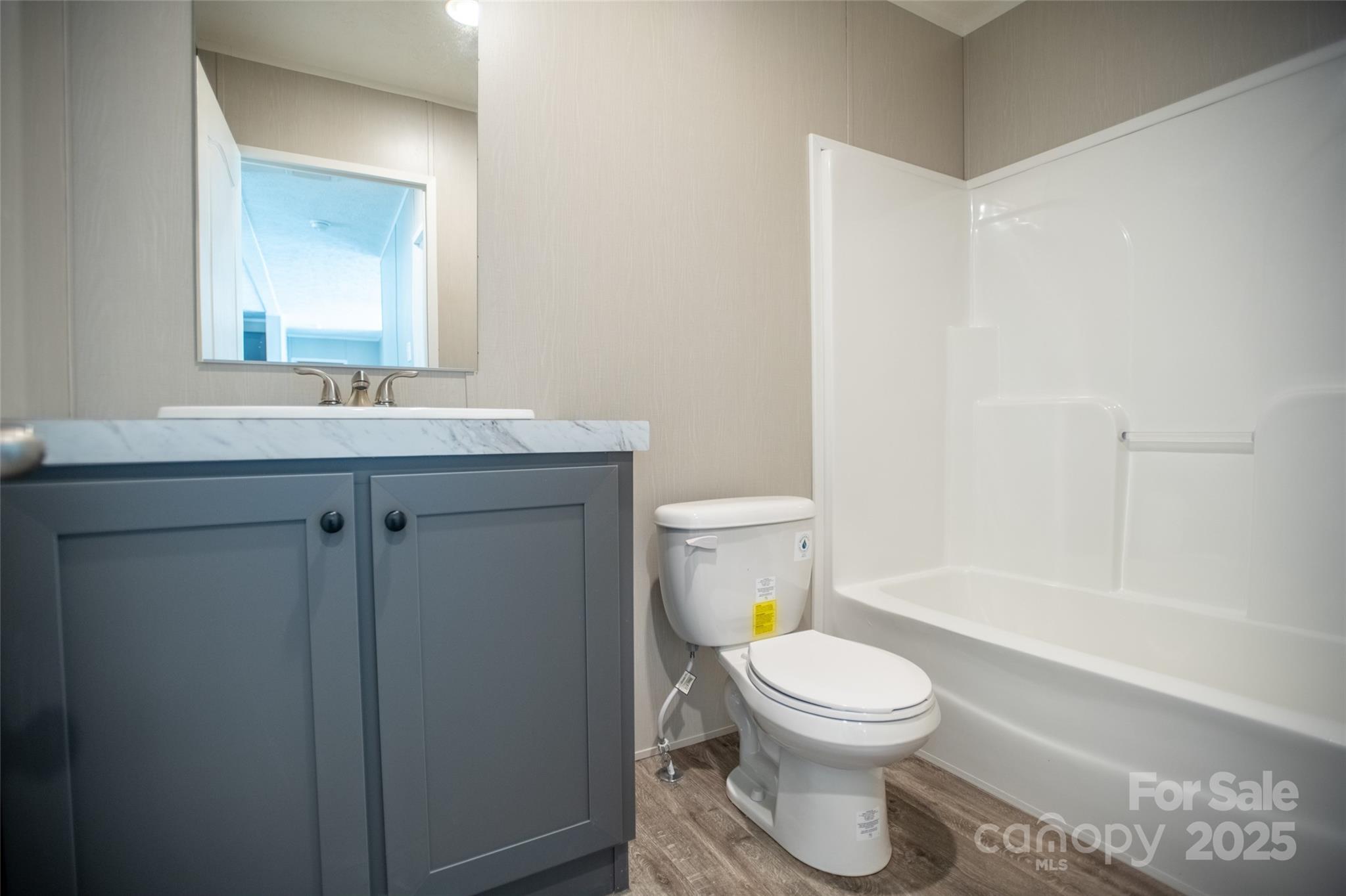 1451 Newfound Road Leicester, NC 28748 - Photo 31 of 39 a bathroom with a toilet a sink and a bathtub