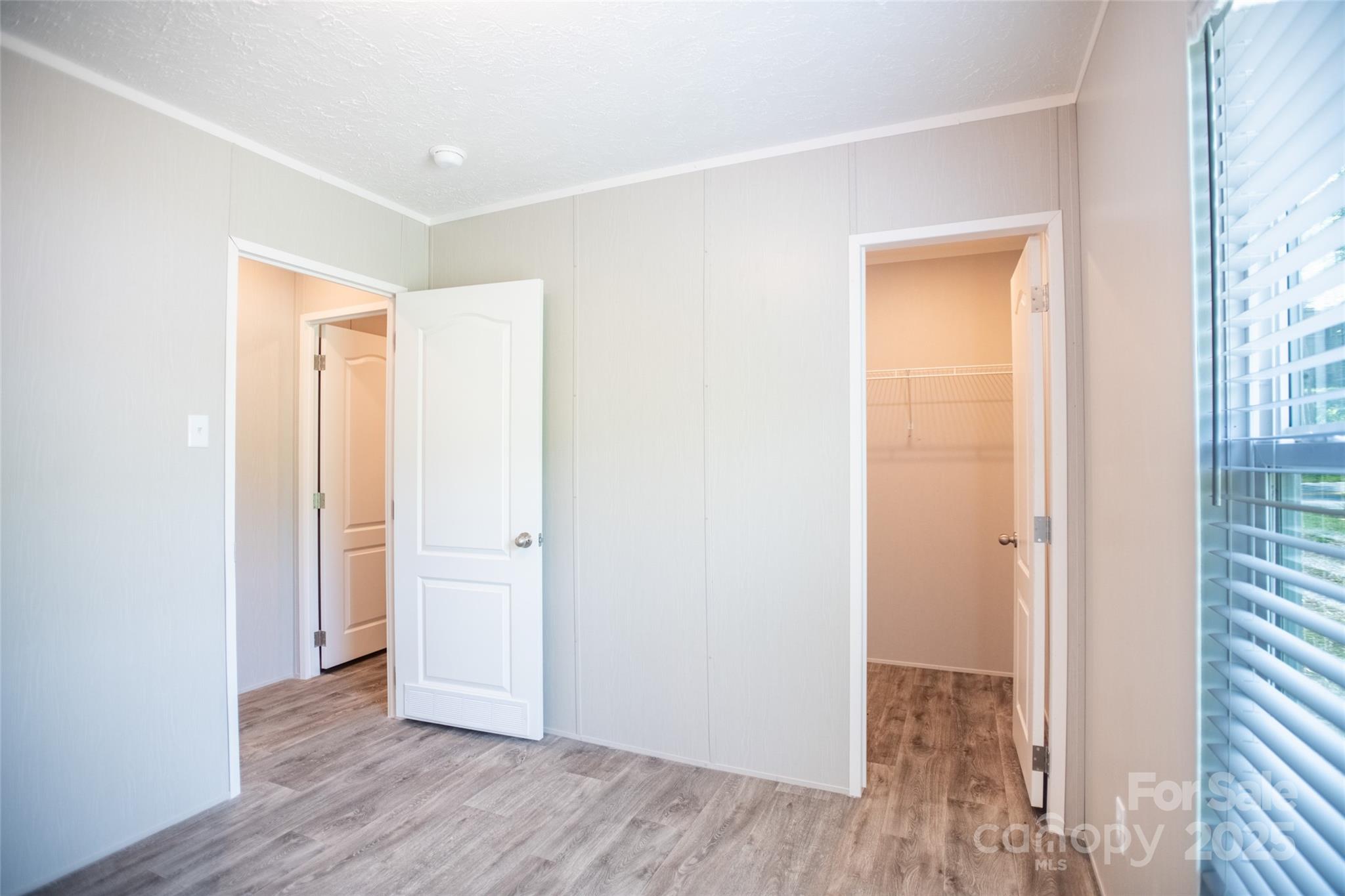 1451 Newfound Road Leicester, NC 28748 - Photo 33 of 39 an empty room with wooden floor and closet