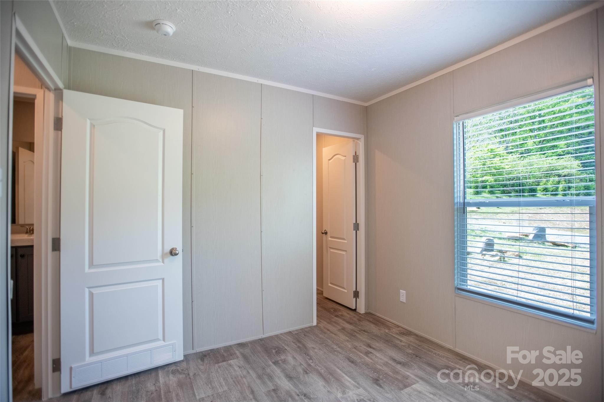 1451 Newfound Road Leicester, NC 28748 - Photo 34 of 39 a view of an empty room with wooden floor and a window