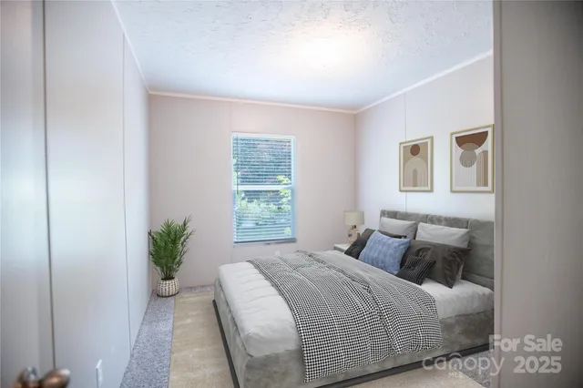 a bedroom with a bed and a potted plant