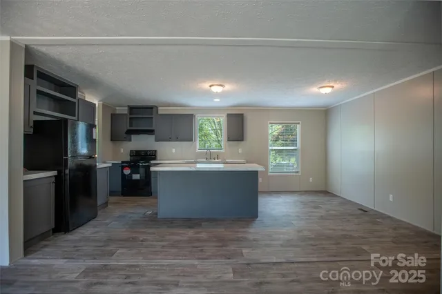 a kitchen with a refrigerator and a stove top oven