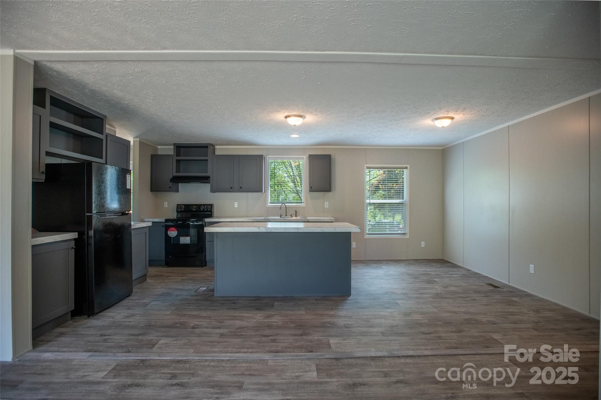 1451 Newfound Road Leicester, NC 28748 - Photo 9 of 39 a kitchen with a refrigerator and a stove top oven