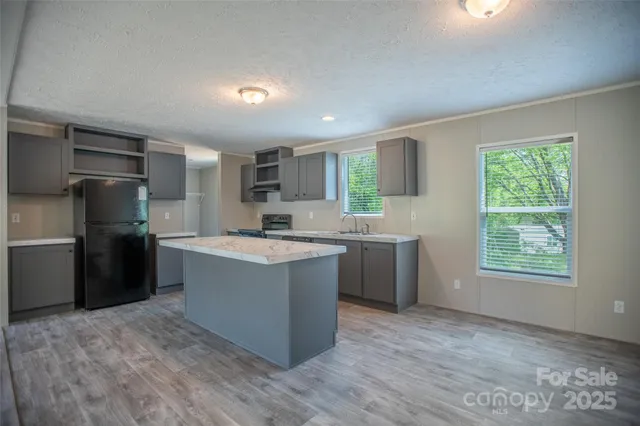 a kitchen with a refrigerator sink and cabinets