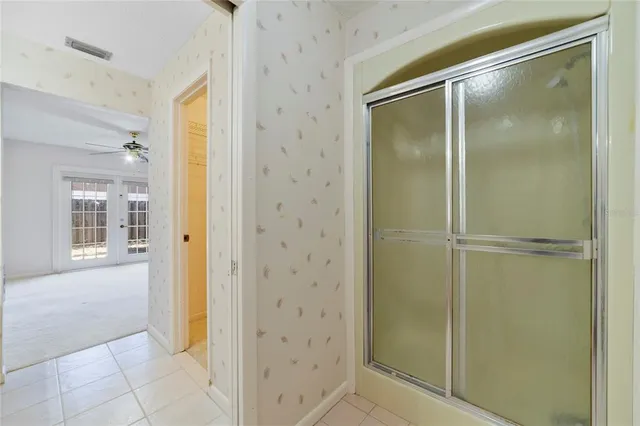 a bathroom with a glass shower door