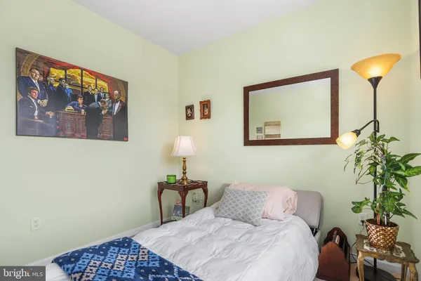 a bedroom with a bed and a fireplace