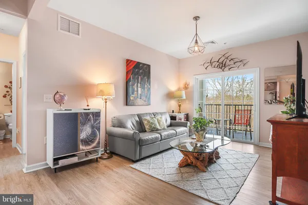 a living room with furniture window and wooden floor